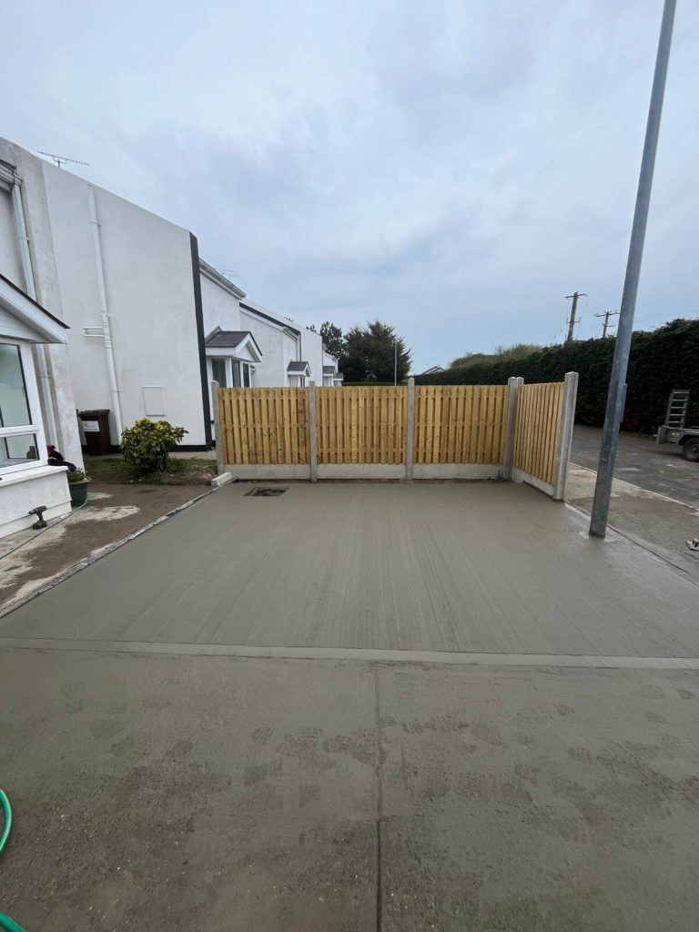 concrete driveway and new fence